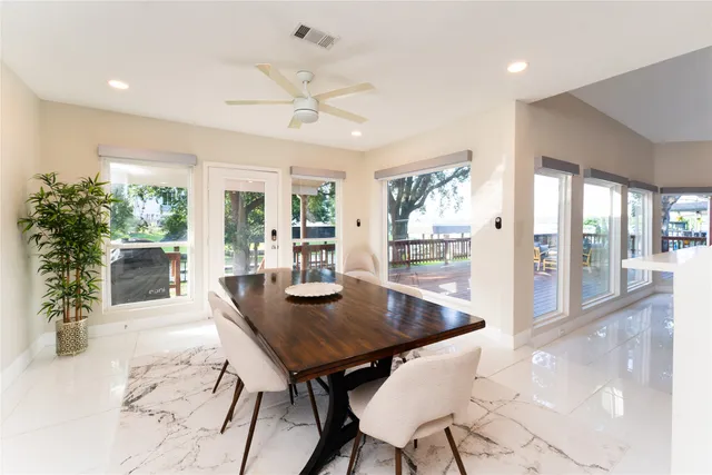 a view of a dining room with furniture and a potted plant