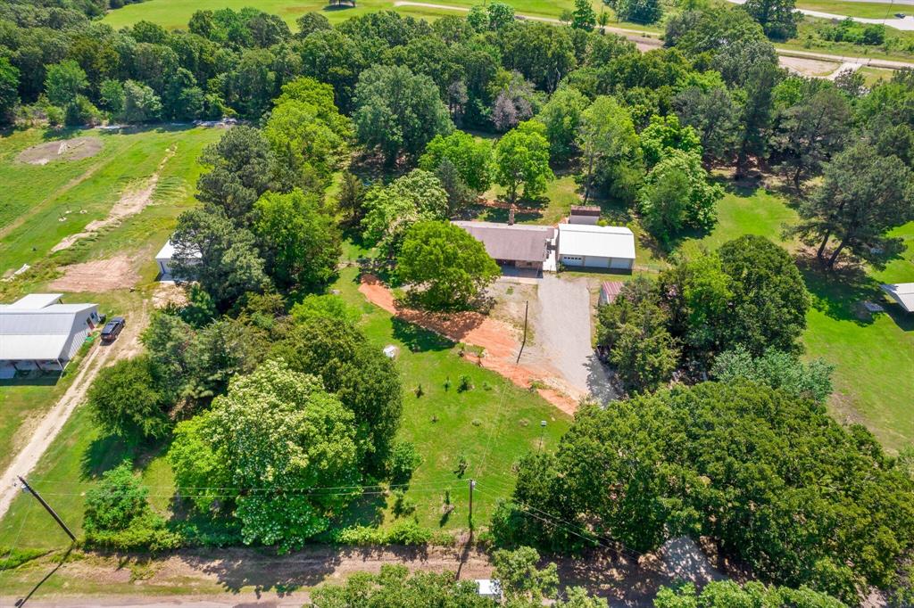 an aerial view of a house with a yard