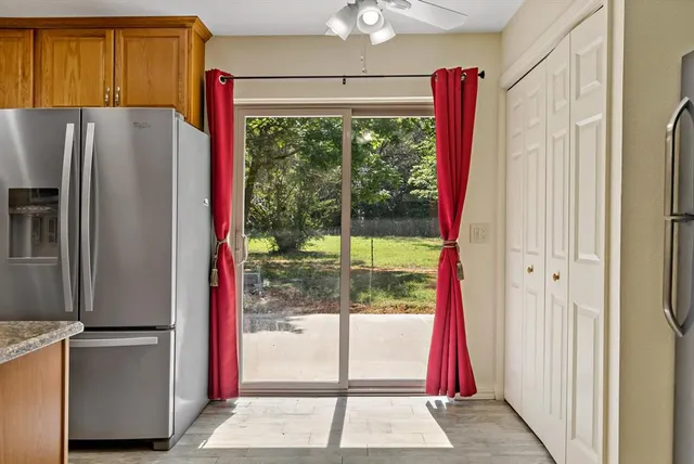 a view of a kitchen with a refrigerator and a window