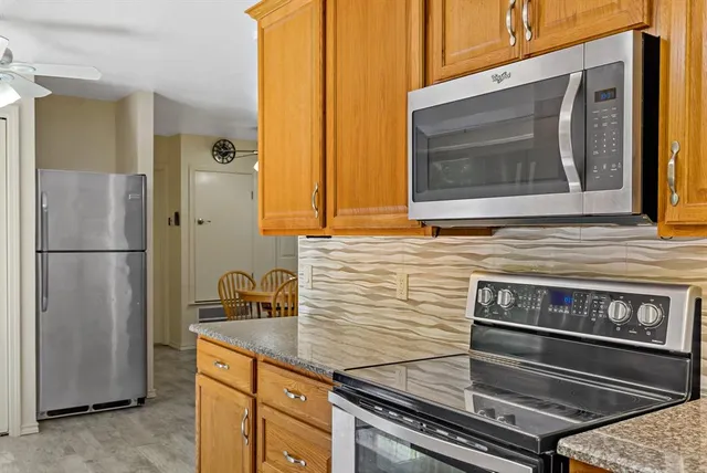 a kitchen with appliances and cabinets