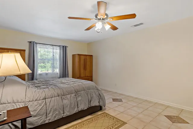 a bedroom with a bed and window