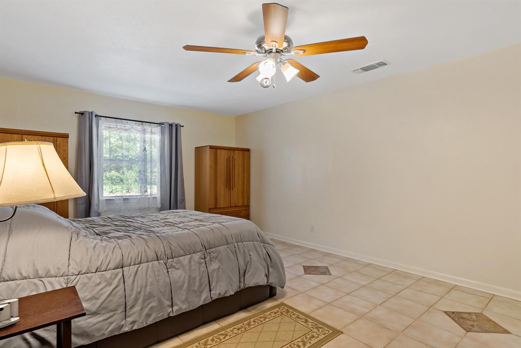 150 County Road Arthur City, TX 75411 - Photo 17 of 37 a bedroom with a bed and window