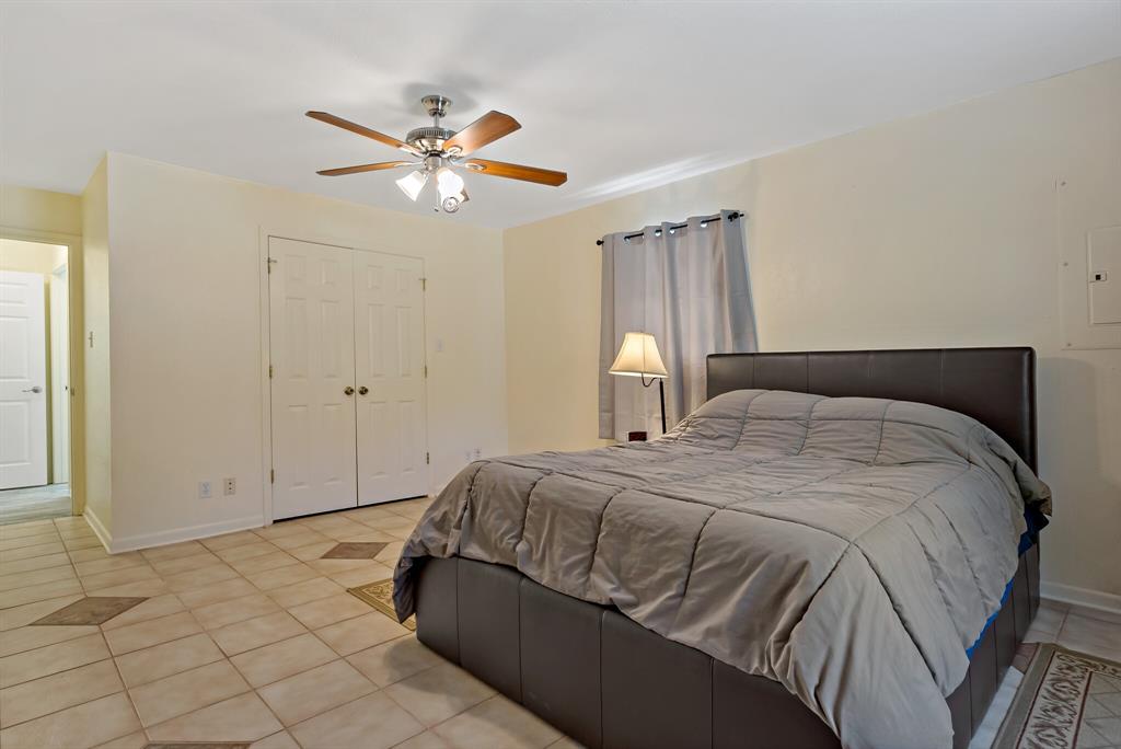150 County Road Arthur City, TX 75411 - Photo 19 of 37 a bedroom with a bed and a chandelier