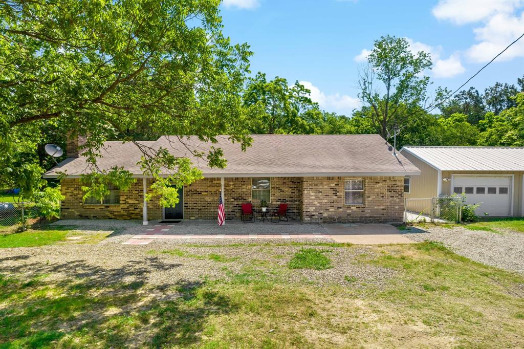 150 County Road Arthur City, TX 75411 - Photo 2 of 37 a view of a house with a yard and potted plants
