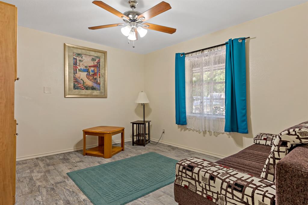150 County Road Arthur City, TX 75411 - Photo 25 of 37 a bedroom with a bed and wooden floor