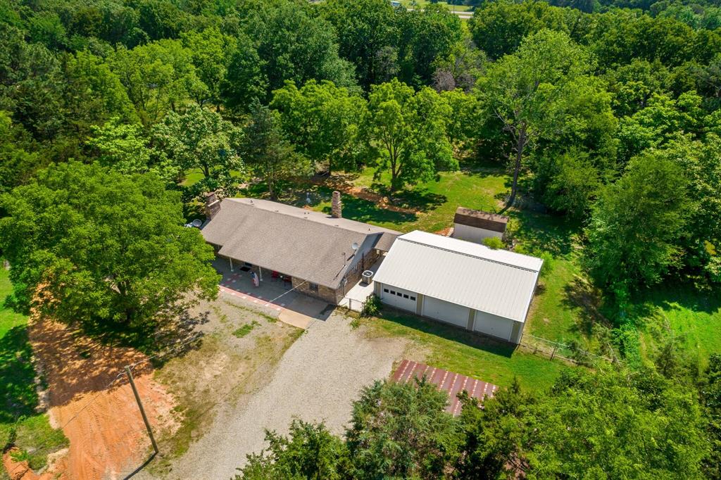 150 County Road Arthur City, TX 75411 - Photo 3 of 37 an aerial view of a house with a yard and lake view