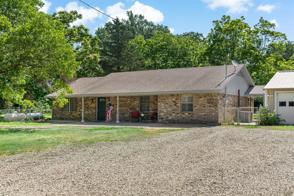 150 County Road Arthur City, TX 75411 - Photo 4 of 37 a aerial view of a house next to a big yard and large trees