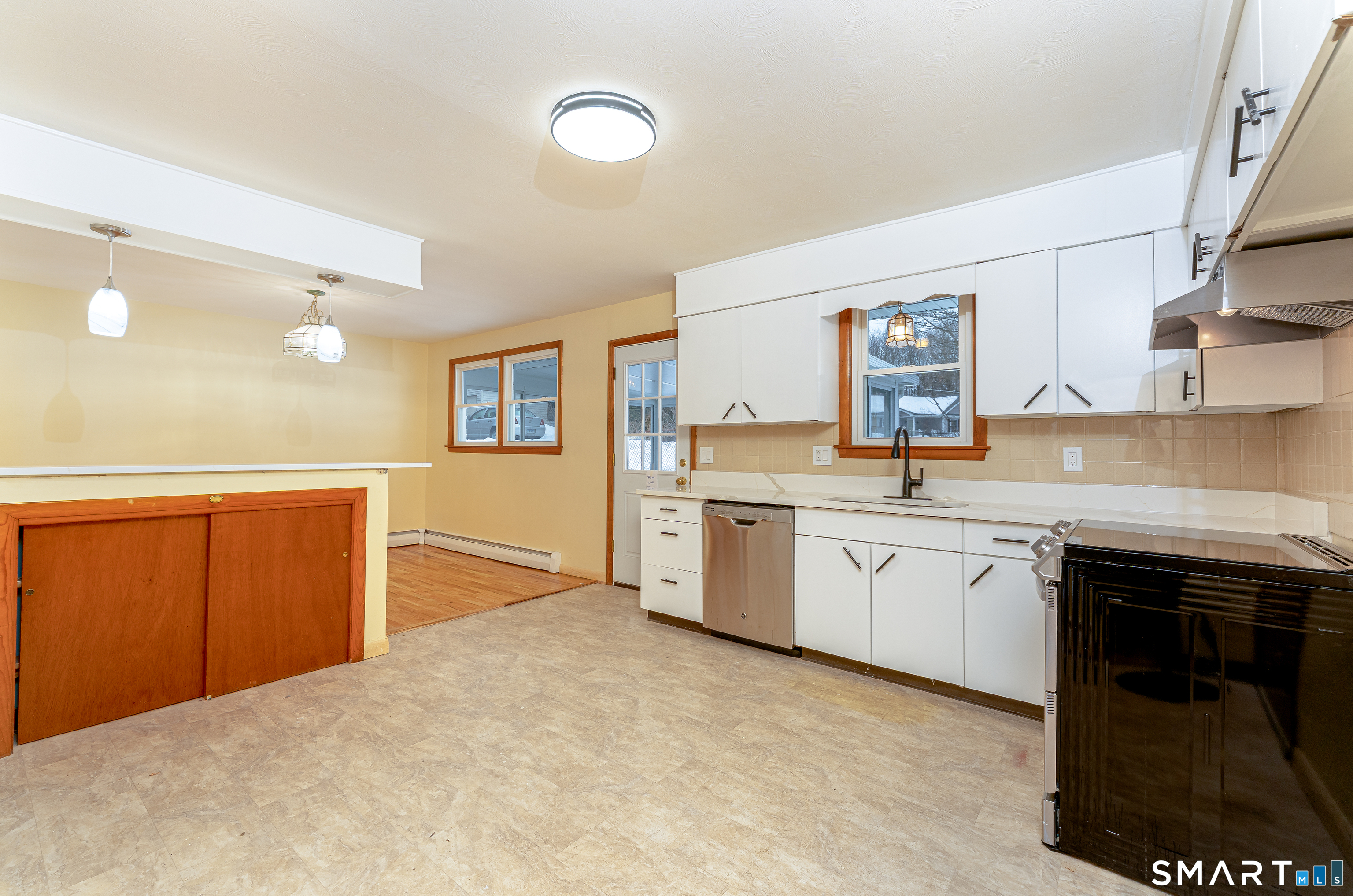 464 French Street Watertown, CT 06779 - Photo 8 of 30 a large kitchen with granite countertop a sink and cabinets
