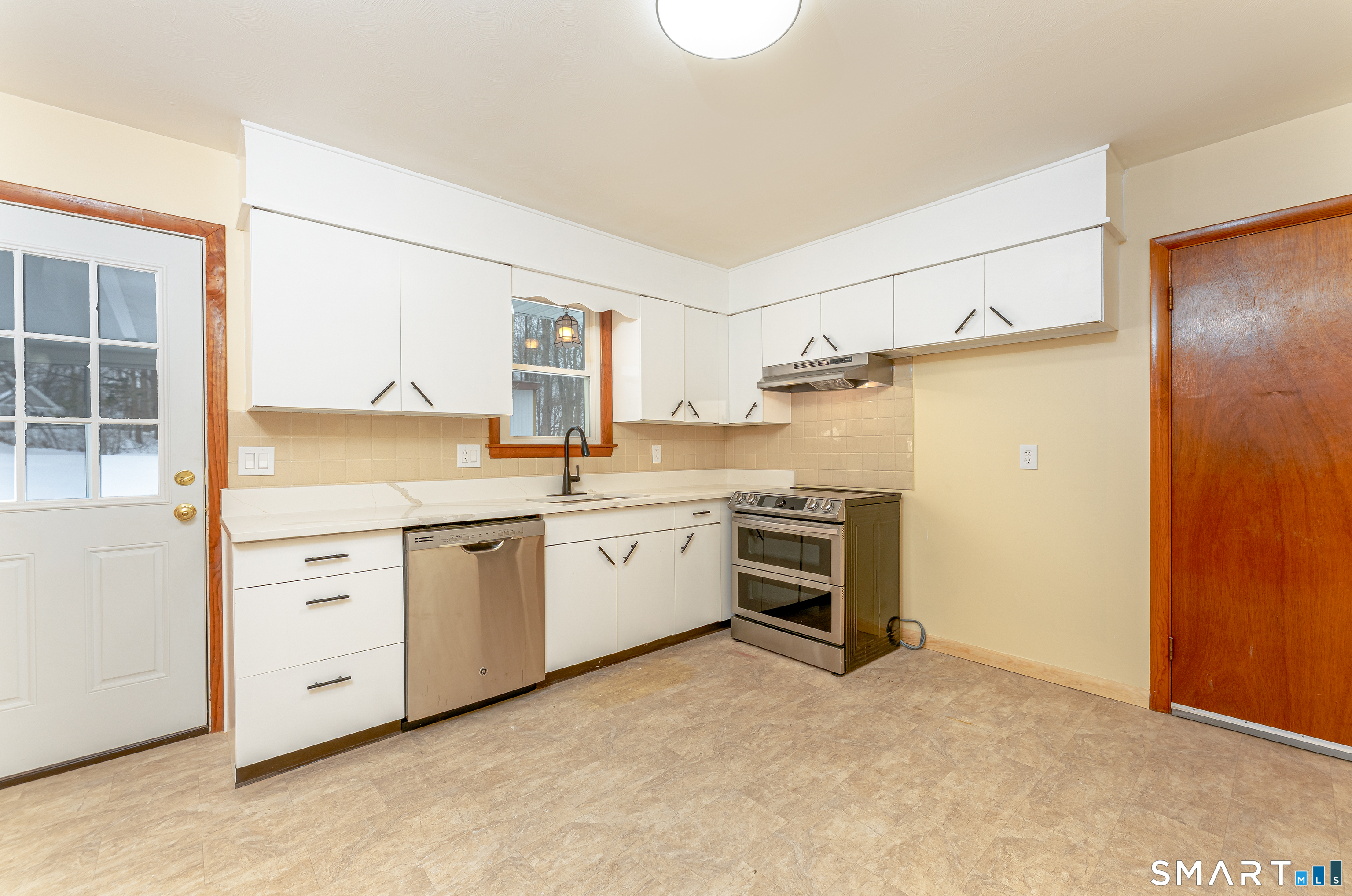 464 French Street Watertown, CT 06779 - Photo 10 of 30 a kitchen with white cabinets and white appliances
