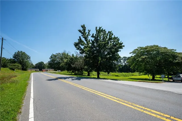a view of road with grass and a trees