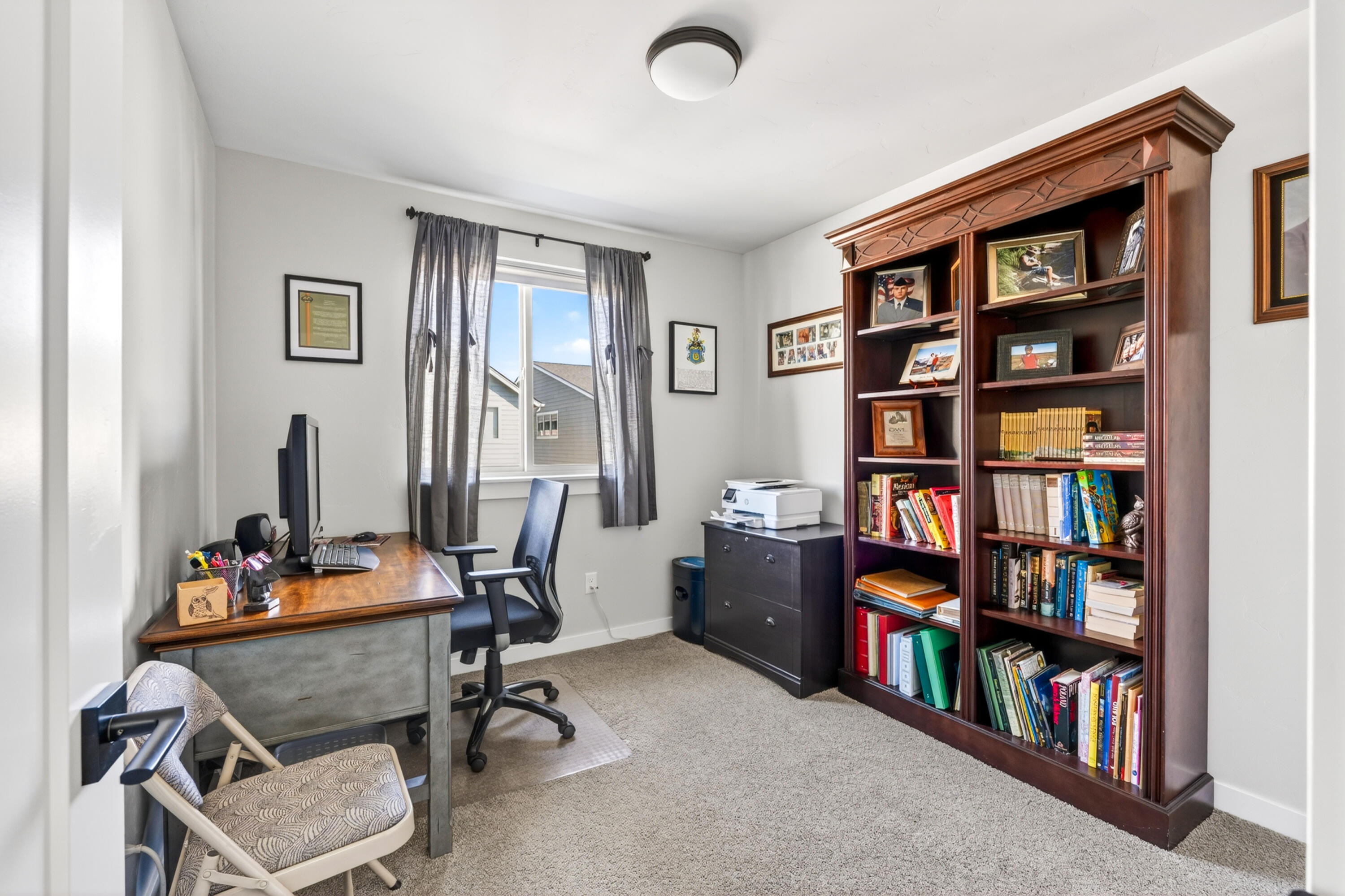 4572 Southwest 37th Street Redmond, OR 97756 - Photo 13 of 19 a view of a workspace with furniture and a bookshelf
