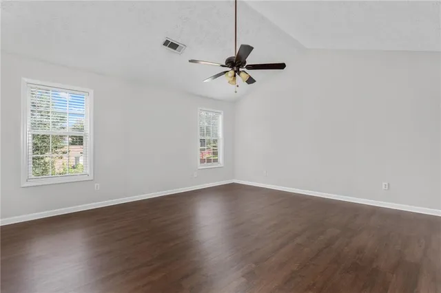 a bathroom with a granite countertop tub sink and mirror