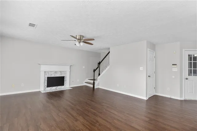 a kitchen with stainless steel appliances granite countertop a stove a sink and a large window