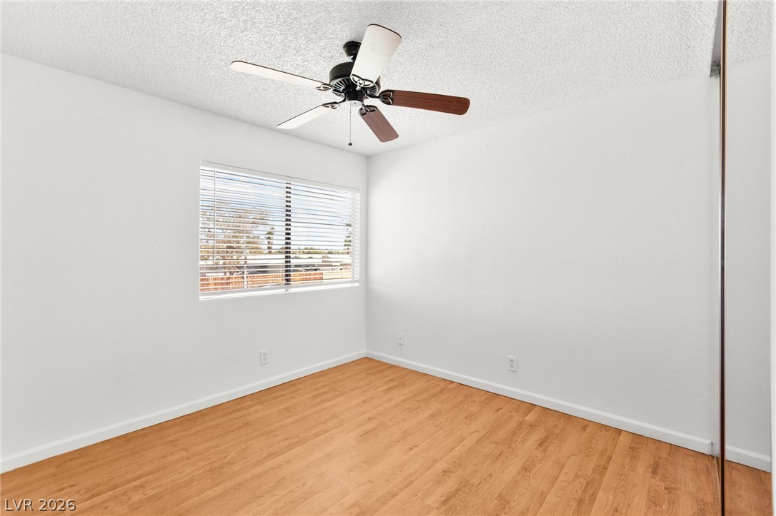 4430 Cranbrook Way Las Vegas, NV 89103 - Photo 44 of 50 A quiet bedroom offering warmth from hardwood flooring and the comfort of a ceiling fan.