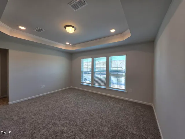 an empty room with a empty space and windows