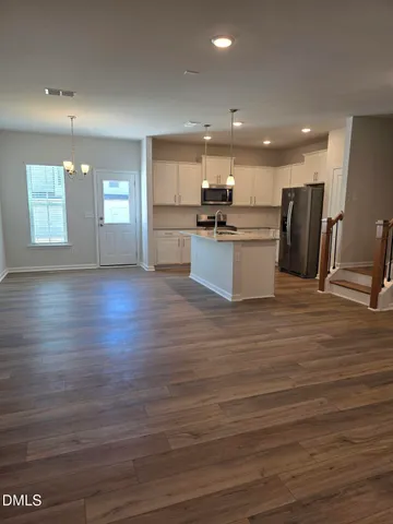 a view of kitchen with cabinets and wooden floor