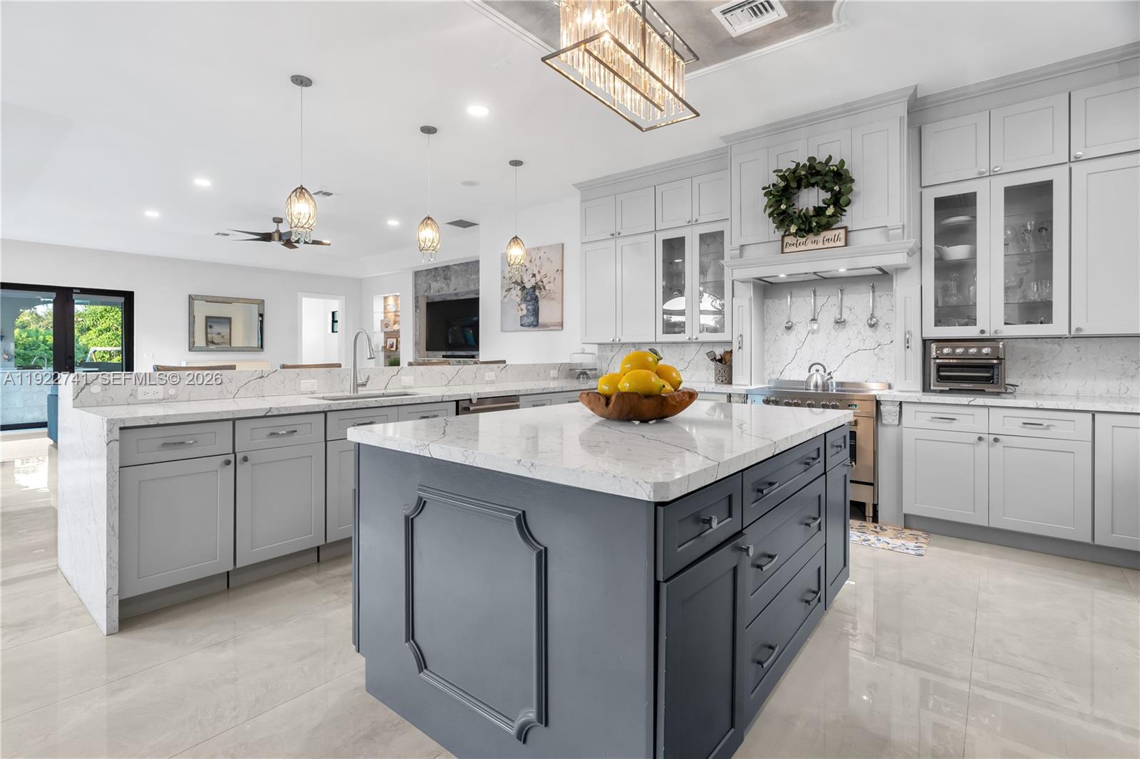 15701 Southwest 254th Street Homestead, FL 33031 - Photo 15 of 50 a kitchen with a sink a stove and cabinets