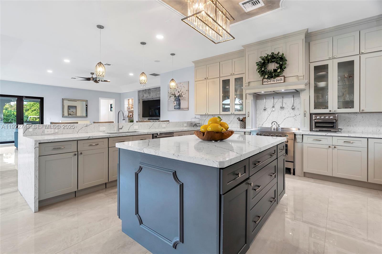 15701 Southwest 254th Street Homestead, FL 33031 - Photo 15 of 50 a kitchen with a sink a stove and cabinets