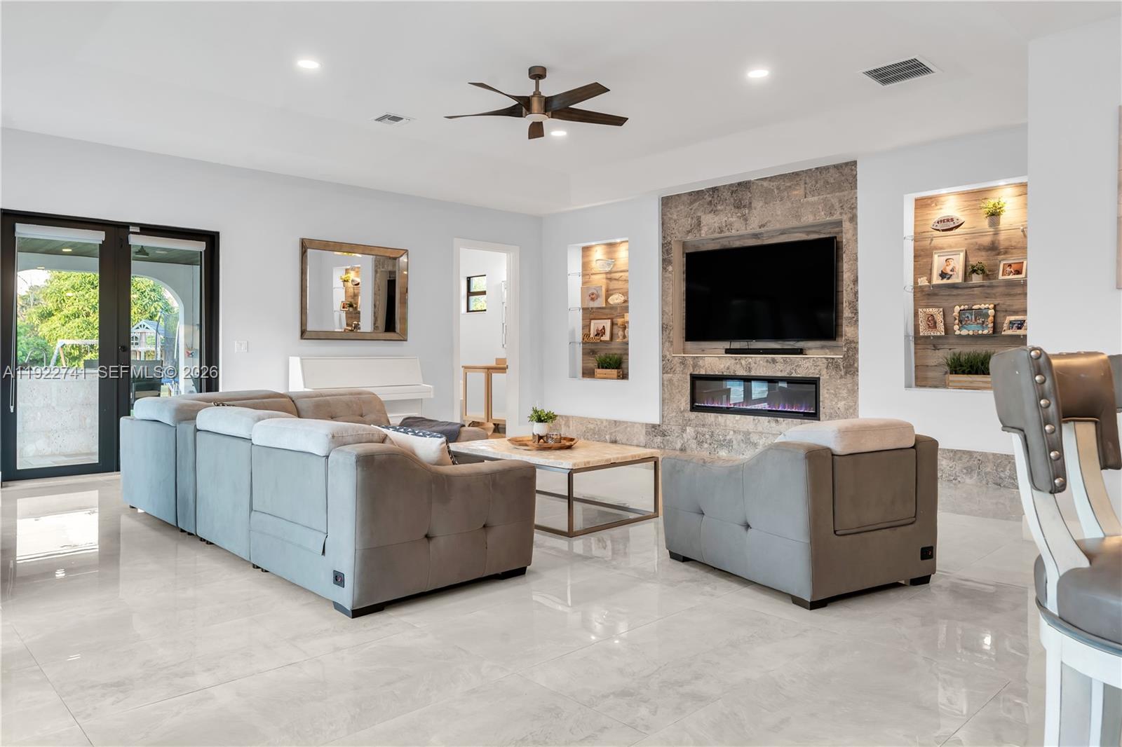 15701 Southwest 254th Street Homestead, FL 33031 - Photo 19 of 50 a living room with furniture and a flat screen tv