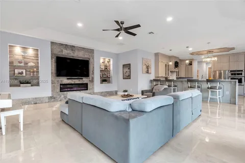 a large kitchen with kitchen island a sink counter space stainless steel appliances and a window