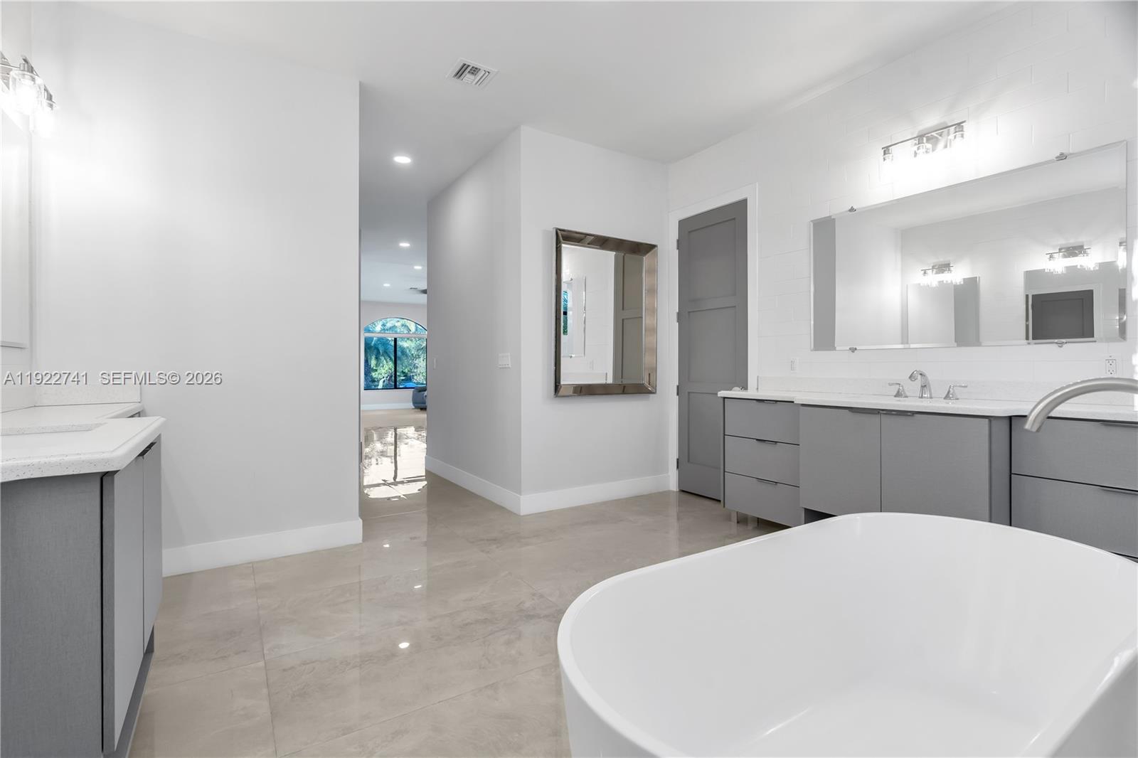 15701 Southwest 254th Street Homestead, FL 33031 - Photo 27 of 50 a bathroom with a sink a vanity and mirror