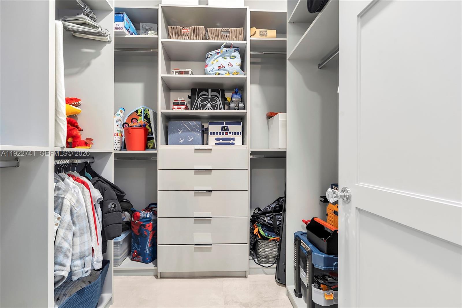 15701 Southwest 254th Street Homestead, FL 33031 - Photo 34 of 50 a view of walk in closet with clothes and shoes