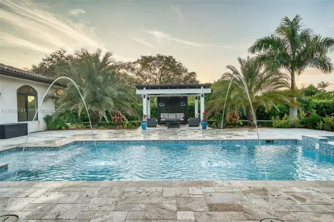 a view of a house with backyard and sitting area