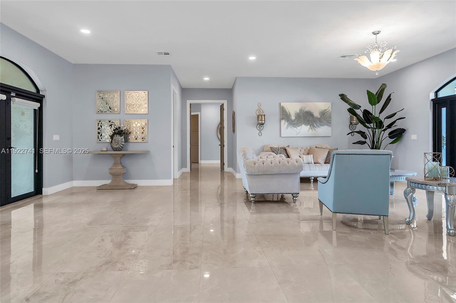15701 Southwest 254th Street Homestead, FL 33031 - Photo 6 of 50 a view of living room filled with furniture and a chandelier