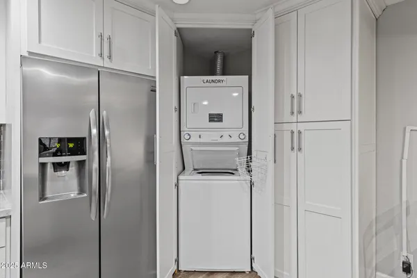a kitchen with a refrigerator and cabinets