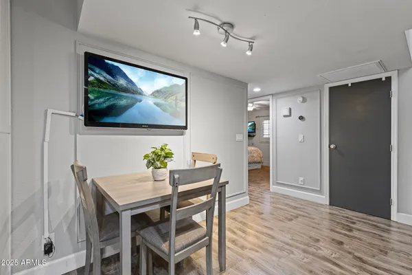 a view of a dining room with furniture wooden floor and window