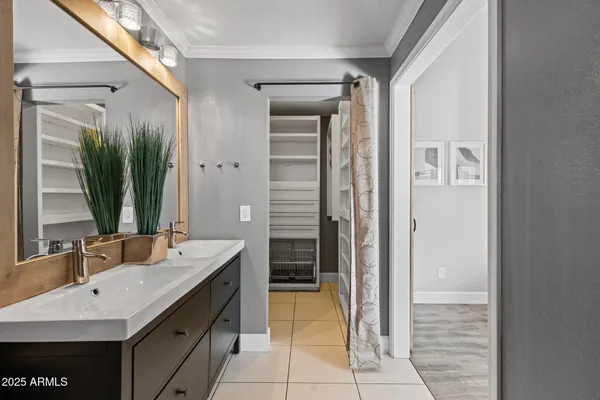 a bathroom with a sink a mirror and a shower