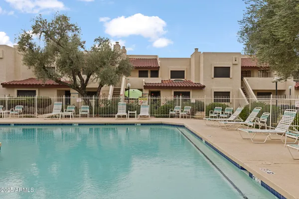 a view of a swimming pool with outdoor seating