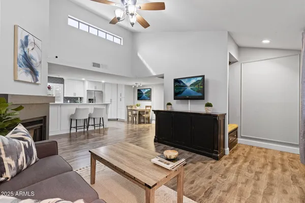 a living room with furniture a dining table and a fireplace