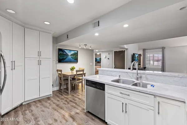 a kitchen with sink and white cabinets