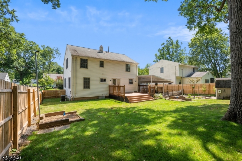 13 Wayne Boulevard Madison, NJ 07940 - Photo 2 of 19 a view of a backyard with table and chairs and a fire pit