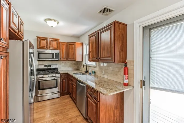 a kitchen with a sink stove and refrigerator