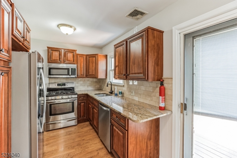 13 Wayne Boulevard Madison, NJ 07940 - Photo 5 of 19 a kitchen with a sink stove and refrigerator