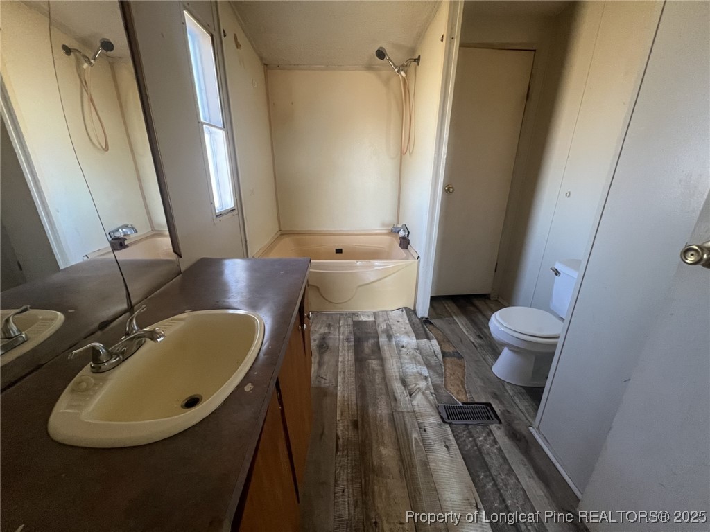 2964 Popes Crossing Road Lumberton, NC 28358 - Photo 11 of 26 a bathroom with a sink and mirror