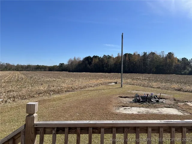 a view of a backyard with wooden floor and lake view