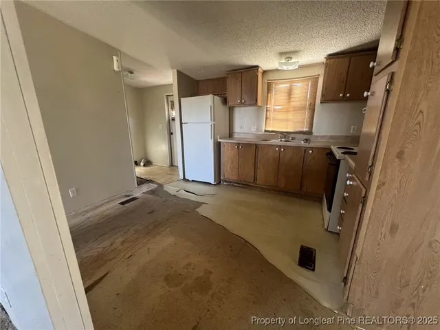 a bathroom with a tub sink and glass door