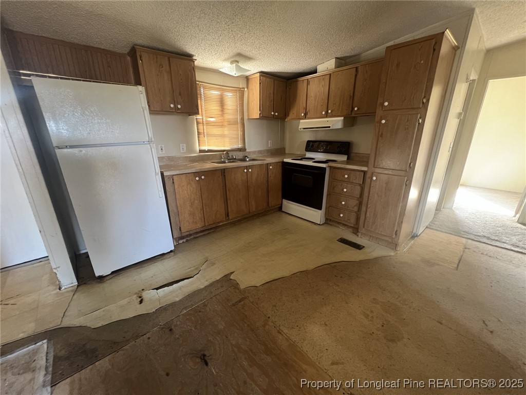 2964 Popes Crossing Road Lumberton, NC 28358 - Photo 6 of 26 a kitchen with granite countertop a refrigerator a sink a stove a microwave a counter top and cabinets