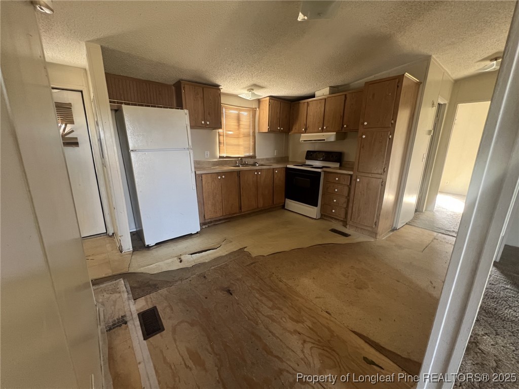 2964 Popes Crossing Road Lumberton, NC 28358 - Photo 7 of 26 a kitchen with granite countertop a refrigerator and a sink