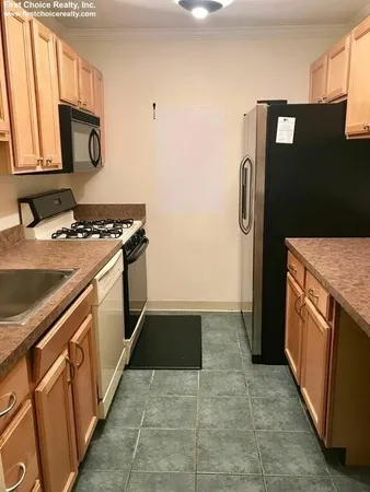 a kitchen with granite countertop a sink and a stove