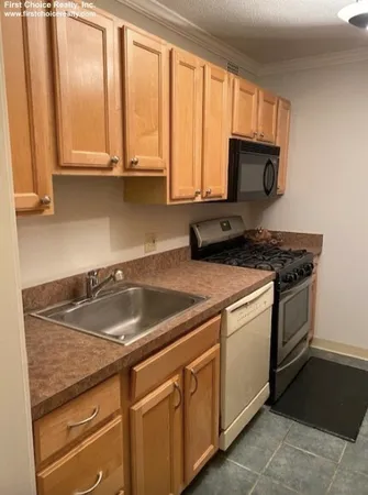 a kitchen with a refrigerator and window
