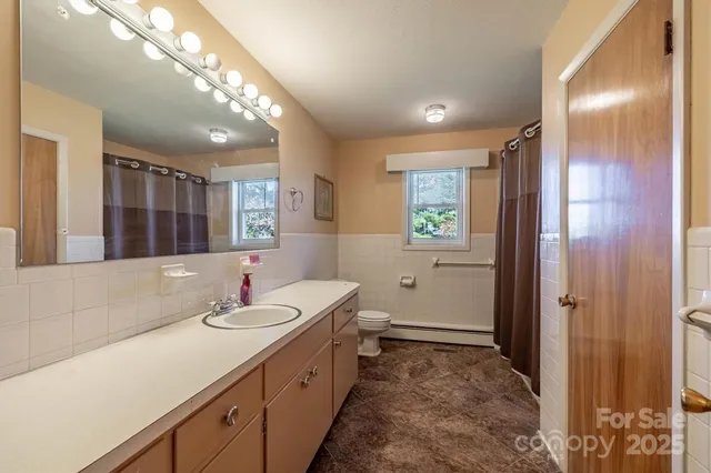 a view of empty room with wooden walls