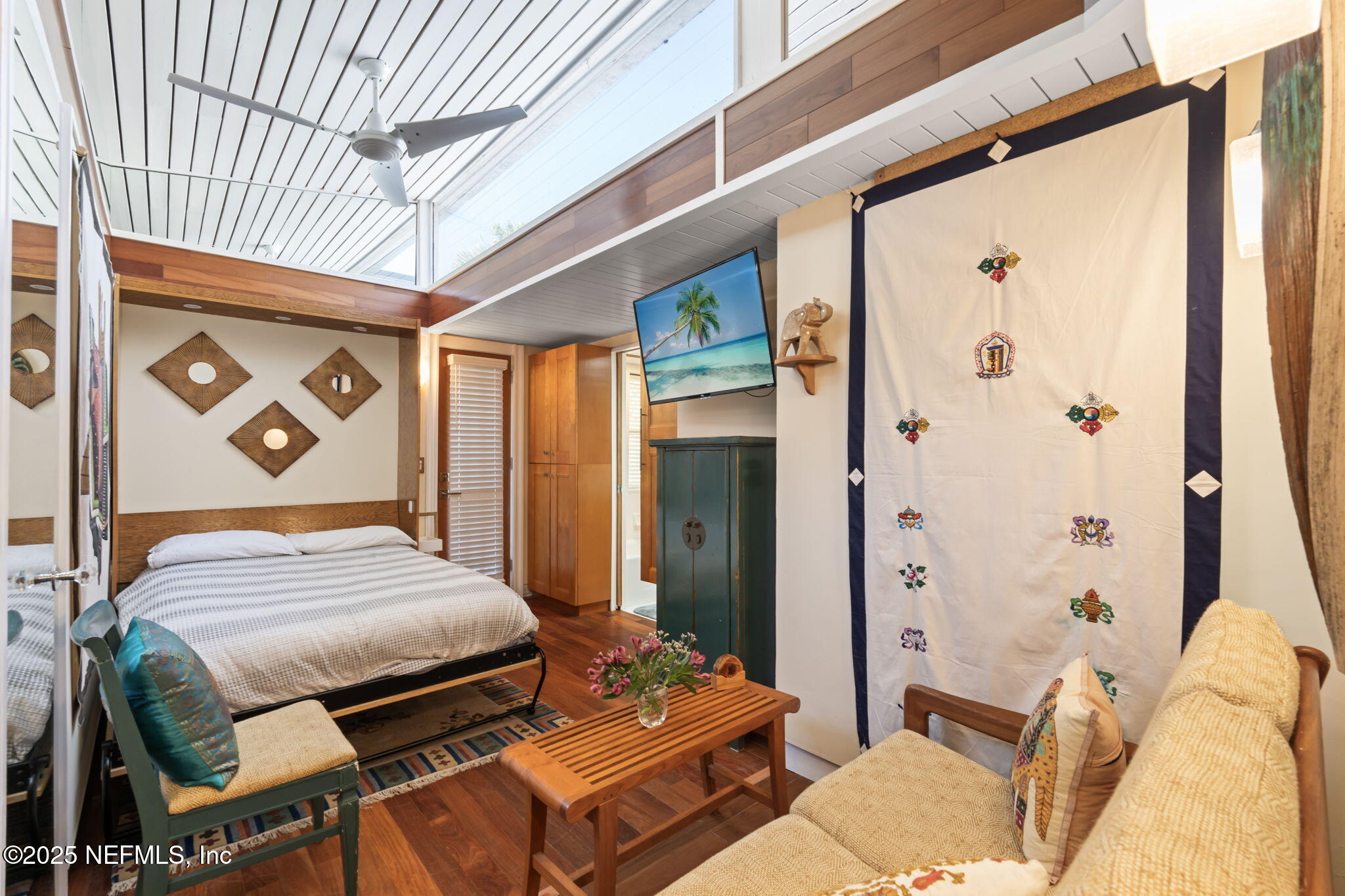 2337 Seminole Road, Unit B Atlantic Beach, FL 32233 - Photo 13 of 19 a bedroom with a bed and wooden floor