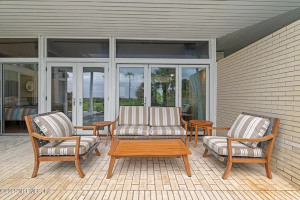 a view of a house with sitting area and garden