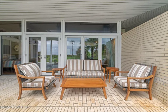 a view of a house with sitting area and garden