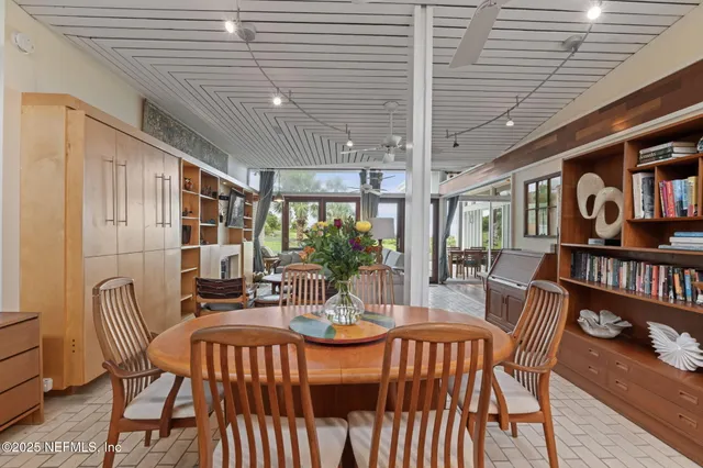 a kitchen with stainless steel appliances kitchen island granite countertop a sink refrigerator and cabinets