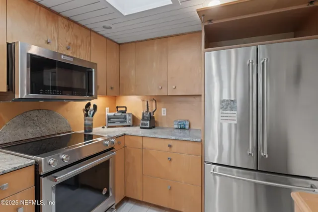 a kitchen with a sink stove and microwave